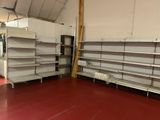 two empty shelves in the middle of a warehouse