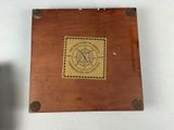 a small wooden box with a stamp on it