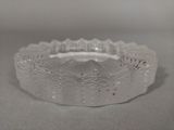 a white glass bowl with a decorative design on it