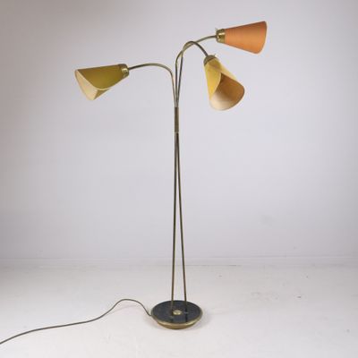 a pair of floor lamps with three shades on each of them