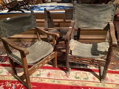 two chairs that are sitting on a rug in a room