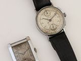 a watch and a watch sitting next to each other