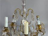 an image of a chandelier made of glass and brass