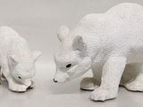 two figurines of a polar bear and a polar bear