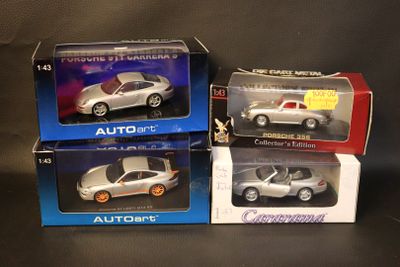 three toy cars are sitting in boxes on a black surface
