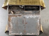 a metal cart with a gold top on a concrete floor