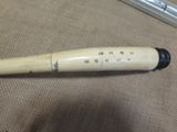 a baseball bat with writing on it laying on a table