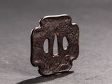 a small piece of metal with holes in it on a table
