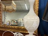 une lampe posée sur une table à côté d'un miroir