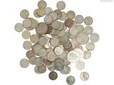 a pile of coins on a white surface