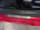a close up of a car door handle with the word peucet on it
