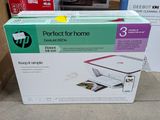 a box of printer sitting on the floor next to a cardboard box