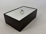 a black box with a silver ring on top of it
