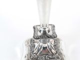 a silver candle holder on a white background