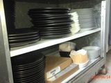 many black and white plates on a shelf in a kitchen