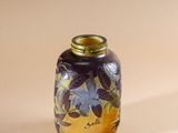 a small glass vase with a floral design on it