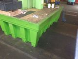 a green box sitting on top of a table in a warehouse
