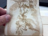 a person holding a piece of paper with a drawing on it