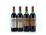 three bottles of wine are lined up on a white surface