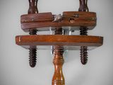 two wooden pegs are mounted to a wall on a shelf