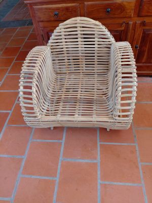 a wicker chair sitting on the floor in a room