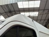 a white van parked inside of a building under a roof