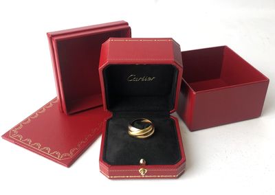 a red box with a gold ring inside of it