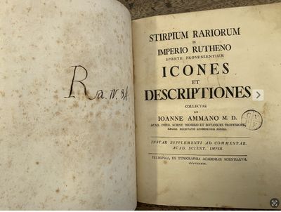 an old book that is open on a table