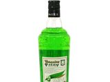 a bottle of green liquid sitting on top of a white surface