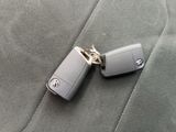 two car keys sitting on the back seat of a car