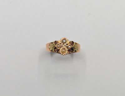 a close up of a gold ring on a white surface