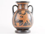 a vase with a black and orange design on it