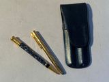 two pens and a case on the table