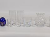 a lot of glass vases and glasses on the table