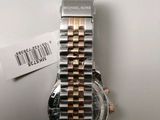 a close up of a watch on a table with a price tag