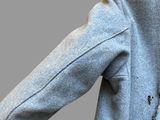 a man wearing a jacket with a tie on it