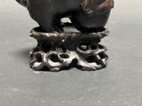 a bronze statue of a bear and two cubs on top of a tree stump