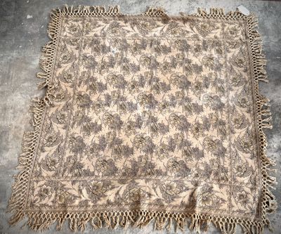 an old rug with fringes and a floral design on it