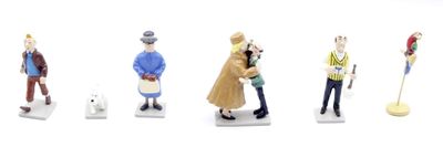 five figurines of different people standing in a row
