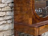 a small wooden cabinet with a mirror on top of it