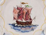 a plate with a painting of a ship on it
