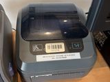 a small printer sitting next to a small printer on a desk