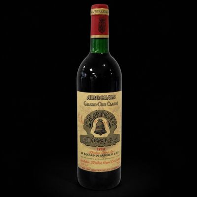 a bottle of red wine on a black background