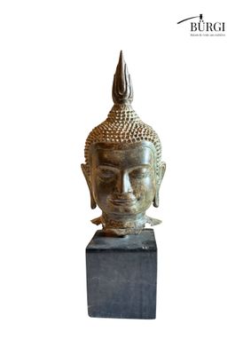 an image of a statue of a buddha head on a block