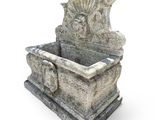 a stone fountain with a bird on top of it