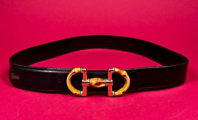 a close up of a black belt with a gold buckle