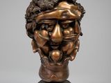 un buste en bronze représentant un homme aux cheveux bouclés et à la barbe
