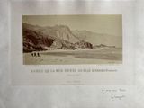 an old picture of a couple of people walking on the beach