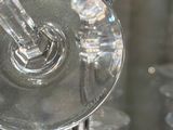many wine glasses that are sitting on a glass table
