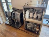two coffee machines that are sitting on a shelf